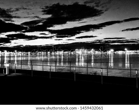 city across the water in black and white