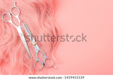 Girls cosplay costume culture, youth fashion and luxury beautician salon concept theme with scissors on hot pink hair with curl isolated on pink background with copy space