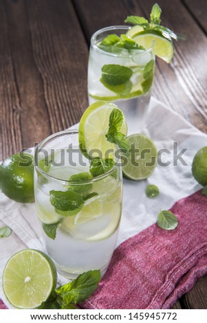 Sparkling Water, Mint and Lime on wooden background