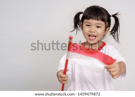 happy indonesian kid with flag over white background