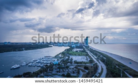 Aerial view on city and skyscrapers before thunderstorm, dramatic sky in Sunny Isles Beach