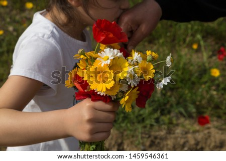 celebrate the victim feast of the elders on the religious holidays.happy mother and teachers day.kiss the mum hand.woman and kid hold the daisy.