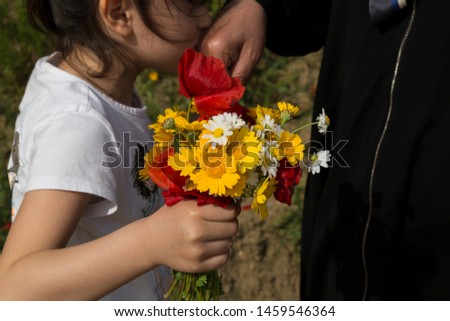 celebrate the victim feast of the elders on the religious holidays.happy mother and teachers day.kiss the mum hand.woman and kid hold the daisy.