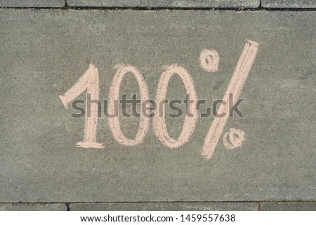 Text 100 percent written on grey sidewalk