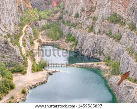 Great old quarry for dolomite mining. Blue lagoon in middle with wooden bridge for tourists.
