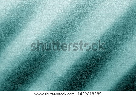 Plastic glittering texture in cyan tone. Abstract architectural background and texture for design.