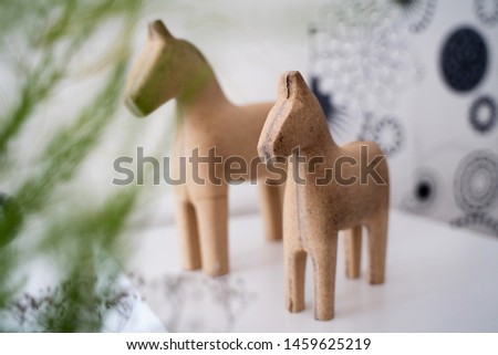 figurines of wooden interior horses on the bedside table in the room