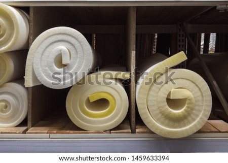 Rolls white and yellow foam rubber building material texture.