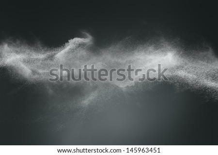 Abstract design of white powder cloud against dark background Royalty-Free Stock Photo #145963451