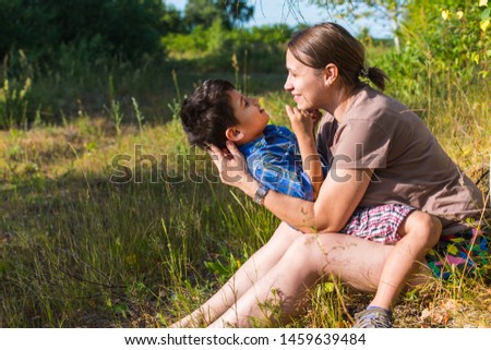 mom and son have fun outdoors in summer