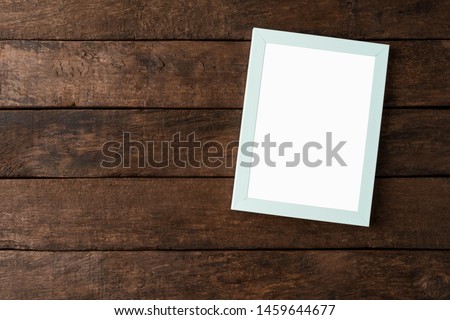 Picture frame with copyspace on wooden background 