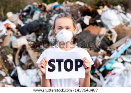 Woman Activist With Stop Poster On Waste Dump. Recycle, Eco, Reuse Concept.