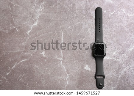 Top view of broken electronic smart watch on marble background, space for text. Repair service