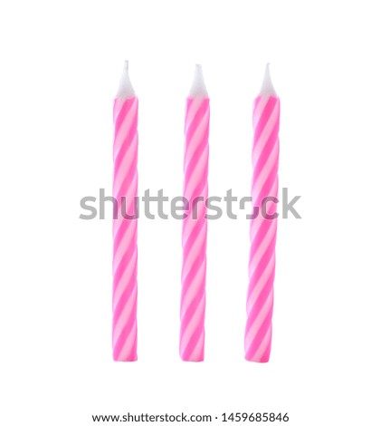 Pink striped birthday candles isolated on white