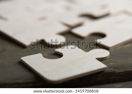 Creative solution for idea - business concept, jigsaw puzzle on the wooden background Royalty-Free Stock Photo #1459700858