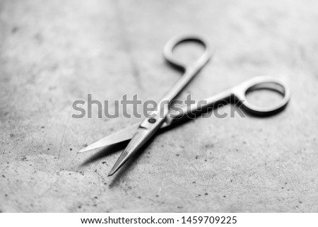 Surgical scissors on a metal table, shallow depth of field.