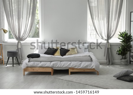 Stylish modern room interior with comfortable double bed