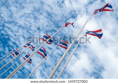 Thai flags and poles on blue sky.
