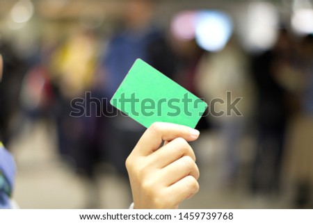 
Hand holding a paper ticket on blurred background