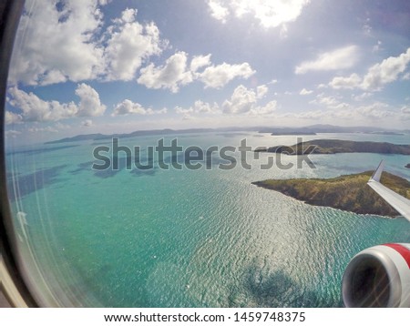 approach (landing) to Hamilton Island. view from the window (porthole | illuminator) of the aircraft, from a height, Queensland, Australia