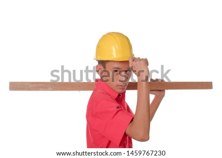 Construction worker carrying a wood plank on his shoulder. Carpenter wearing sefety helmet isolated on white background. Protective equipment concept.
