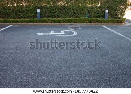 The sign on the street indicates the parking lot for the disabled