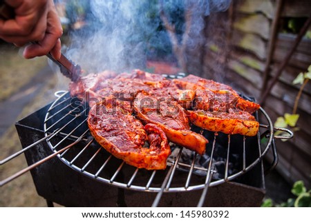 Flames grilling a steak on the BBQ 