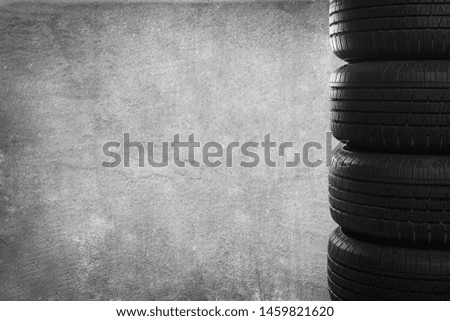 A stack of tires on grunge background with copy space.