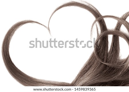Brown hair in shape of heart, isolated on white background