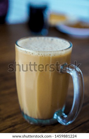 The Tarik, a hot milk tea beverage on a wooden table