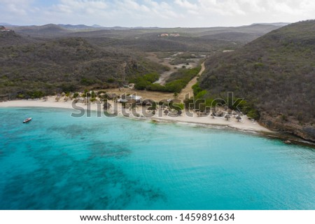 Aerial view of coast of Curaçao in the  Caribbean Sea with turquoise water, white sandy beach and beautiful coral reef at Playa Cas Abao