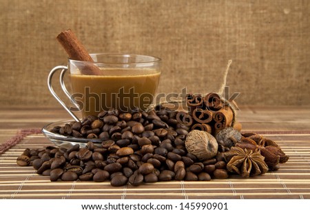 Cup of coffee, grains, and spices against the canvas