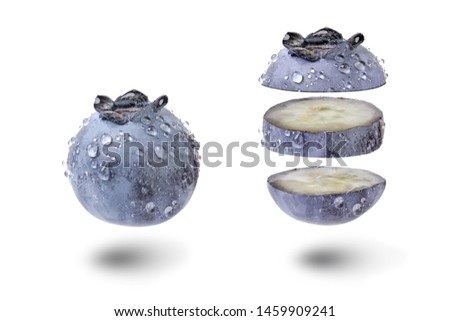 Floating blueberry cut with water drops isolated on white background. Fresh fruit unique caption. Natural organic levitating bilberry. Healthy snack. Creative photo, studio lighting.