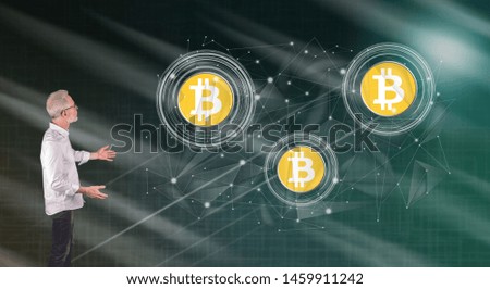 Businessman showing a bitcoin currency concept on a wall screen