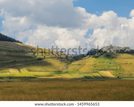 View of Plains of Castelluccio with the ancient village on the background, Umbria, Italy.