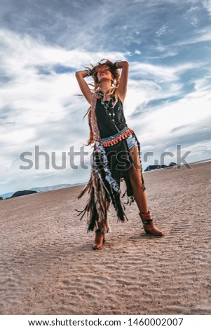 young cheerful stylish woman on the beach at sunset