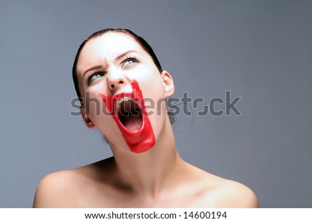 red painted girl with opened mouth is screaming