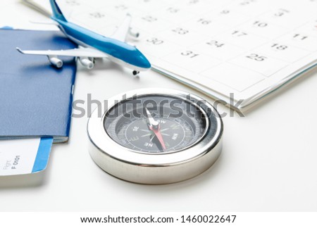 Flight tickets and compass isolated on white background close up