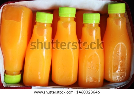 Close up Squeezed orange juice packed in clear plastic bottles Placed in the cooler box
