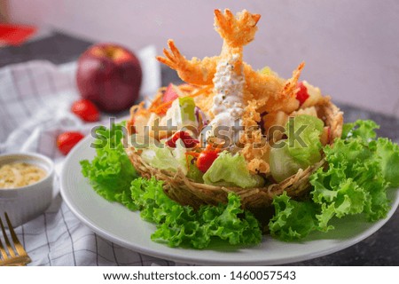 Tempura Jumbo Shrimps with salad and salsa dip on white plate.