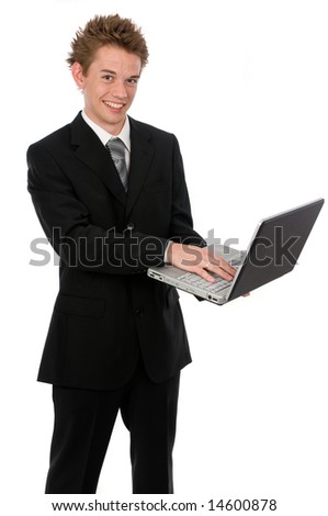A young businessman standing up using a laptop