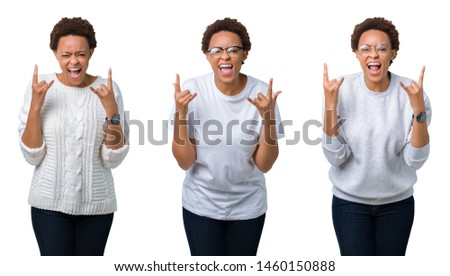Young african american woman with afro hair over isolated background shouting with crazy expression doing rock symbol with hands up. Music star. Heavy concept.