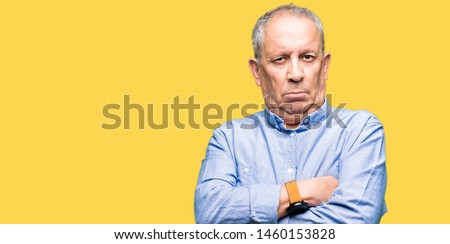 Handsome senior businesss man wearing elegant shirt skeptic and nervous, disapproving expression on face with crossed arms. Negative person. Royalty-Free Stock Photo #1460153828
