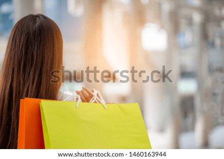 Shopaholic and lifestyle concept.Asian shopaholic woman shopping at department store,Happy Couple of love holding colorful shopping bag in fashion street,end of year sale.
