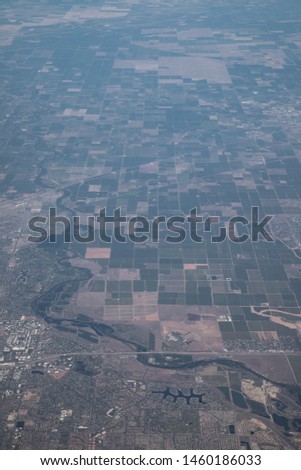 Aerial view over arid rural farm land in Central California