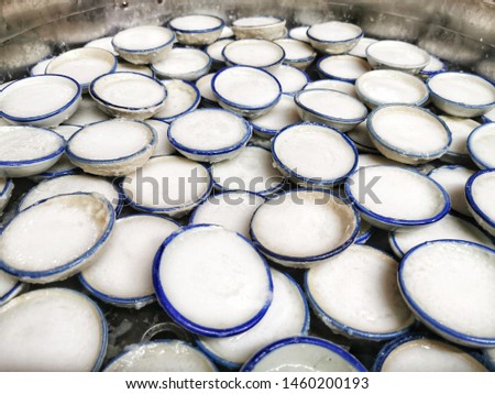 Thai sweet steamed dessert. The main ingredients are coconut milk and sugar or coconut milk custard in small porcelain cup.