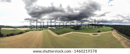 Lines over a field with clouds