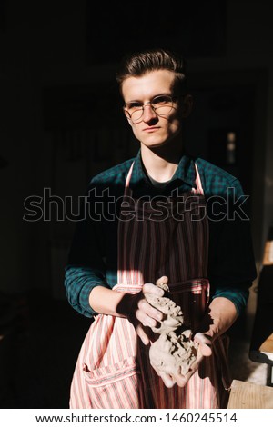 Male potter works with clay. Hand's of man creating ceramic product