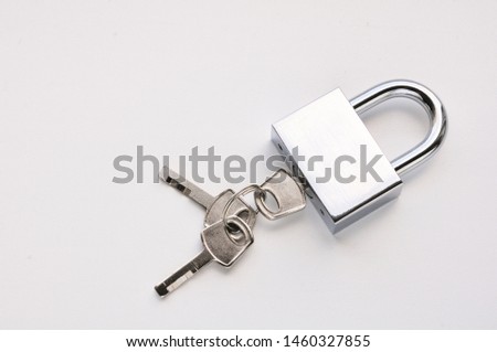 Locked silver lock with three keys on a white background.