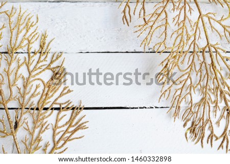 gold branches, yellow leaves on a white wooden background with copy space. flat layout, top view